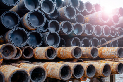 Drill Pipe Of Oil Drilling Platforms. Stack Of Oil Well Casing Bundles At The Pin End Of Casing. Downhole Drilling Rig.