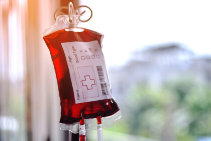 Blood Bag From Blood Donation For Blood Transfusion Hanging Against The Morinjing Sunrise In The Hospital.